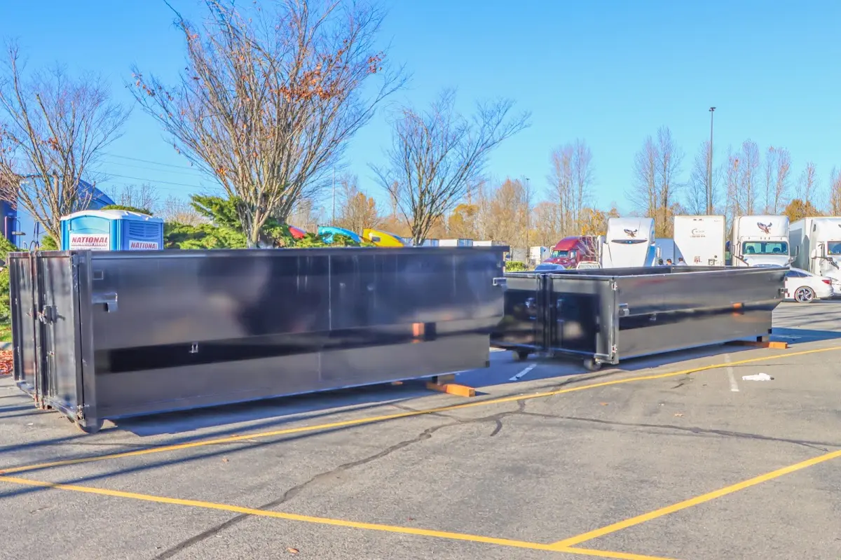 Professional dumpster rental service with roll-off container on residential driveway in Dunmore